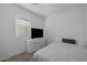 Modern bedroom featuring a white color scheme, carpeted floor, and a television atop a dresser at 7343 W Hughes Dr, Phoenix, AZ 85043