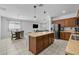 Bright kitchen featuring stainless steel appliances, a central island, and an adjacent dining area at 7343 W Hughes Dr, Phoenix, AZ 85043