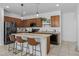 Spacious kitchen with stainless steel appliances, a center island, and stylish pendant lighting at 7343 W Hughes Dr, Phoenix, AZ 85043