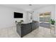Comfortable living space with tile flooring, a modern sofa, and sliding glass doors to the patio at 7343 W Hughes Dr, Phoenix, AZ 85043