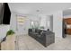Cozy living room featuring a large sectional sofa and access to a patio at 7343 W Hughes Dr, Phoenix, AZ 85043