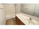 Bright bathroom featuring a tub shower, toilet, and vanity with storage at 7425 W Crown King Rd, Phoenix, AZ 85043