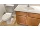 Neutral bathroom featuring a toilet, sink and wood vanity with tile floors at 7425 W Crown King Rd, Phoenix, AZ 85043