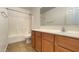 Well-lit bathroom featuring a tub shower, toilet, and vanity with storage at 7425 W Crown King Rd, Phoenix, AZ 85043