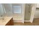 Bathroom with a soaking tub, shower, and vanity sink with wood cabinetry at 7425 W Crown King Rd, Phoenix, AZ 85043