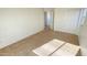 A view of the bedroom features neutral carpet and natural light from a window at 7425 W Crown King Rd, Phoenix, AZ 85043