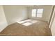 A spacious carpeted bedroom features natural light and plenty of space at 7425 W Crown King Rd, Phoenix, AZ 85043