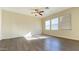 Bright living room featuring modern flooring, large windows, and a ceiling fan at 7425 W Crown King Rd, Phoenix, AZ 85043