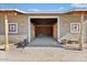 Open barn with a concrete entrance, wooden walls, beams, and tiled decorations at 870 S La Paz Rd, Maricopa, AZ 85139