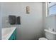 Bathroom featuring a teal vanity, sink, towel rack, decorative picture and a toilet at 870 S La Paz Rd, Maricopa, AZ 85139