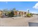 Quaint mobile home with neutral siding, covered porch and xeriscaped desert landscaping at 870 S La Paz Rd, Maricopa, AZ 85139
