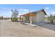 Newly constructed home with a covered porch, natural wood beams, and xeriscape landscaping at 870 S La Paz Rd, Maricopa, AZ 85139