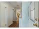 Hallway with entry door and access to bedrooms and bathrooms with wood flooring at 870 S La Paz Rd, Maricopa, AZ 85139
