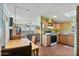 Eat in kitchen with wood cabinets and countertops, adjacent to living room with view at 870 S La Paz Rd, Maricopa, AZ 85139