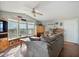 Cozy living room with large windows, wood floors, and comfortable seating arrangement at 870 S La Paz Rd, Maricopa, AZ 85139