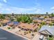 An aerial view showing the landscape of the home, the area around it and nearby houses at 928 W Natal Ave, Mesa, AZ 85210
