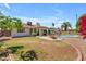 Spacious backyard featuring lush green grass, a pool, and a cozy outdoor seating area at 928 W Natal Ave, Mesa, AZ 85210