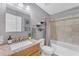Bathroom with granite countertop, tiled shower, and stylish decor at 928 W Natal Ave, Mesa, AZ 85210