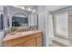 Bathroom featuring a vanity, mirror, granite counter, sink, and a glass-enclosed shower at 928 W Natal Ave, Mesa, AZ 85210