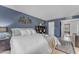 Bedroom featuring modern design, blue walls, a comfortable bed, and stylish decor at 928 W Natal Ave, Mesa, AZ 85210