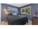 Cozy bedroom with a queen-sized bed, accent lighting, and a window at 928 W Natal Ave, Mesa, AZ 85210