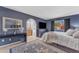Primary bedroom featuring blue walls, stylish furnishings, and access to an ensuite bathroom at 928 W Natal Ave, Mesa, AZ 85210