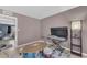 Bonus room with drum set and keyboard, featuring neutral paint and doorway to bedroom at 928 W Natal Ave, Mesa, AZ 85210