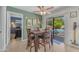 Bright dining area with a table, four chairs, and sliding door access to the backyard pool and outdoor seating at 928 W Natal Ave, Mesa, AZ 85210