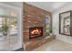 Charming brick fireplace with a hearth, window, glass doors to the patio, and decorative accents at 928 W Natal Ave, Mesa, AZ 85210
