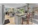 Eat-in kitchen featuring gray cabinets, a stainless steel range, island with bar seating and natural light at 928 W Natal Ave, Mesa, AZ 85210