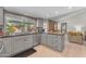 Bright kitchen showcasing gray cabinets, granite counters, with views of the brick fireplace at 928 W Natal Ave, Mesa, AZ 85210