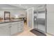Open kitchen with stainless steel refrigerator and gray cabinetry, with an eat-in kitchen nearby at 928 W Natal Ave, Mesa, AZ 85210