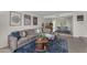 Inviting living area featuring a large sectional sofa, stylish decor, and an open layout that flows into the dining area at 928 W Natal Ave, Mesa, AZ 85210