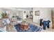 Spacious living area featuring a plush sectional sofa, an accent chair, and an open layout connecting to other living spaces at 928 W Natal Ave, Mesa, AZ 85210