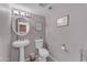 Stylish powder room with pedestal sink, decorative mirror, and neutral paint at 928 W Natal Ave, Mesa, AZ 85210