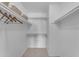 Spacious walk-in closet with multiple shelves and hanging rods for clothing storage at 928 W Natal Ave, Mesa, AZ 85210