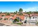 Expansive aerial shot showcasing a lovely single-story home with a red tile roof surrounded by palm trees at 10102 E Dreyfus Ave, Scottsdale, AZ 85260
