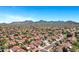 Breathtaking aerial view capturing a large community with red tile roofs against a backdrop of distant mountains at 10102 E Dreyfus Ave, Scottsdale, AZ 85260