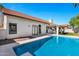 Beautiful backyard with a refreshing pool, spacious patio, and the home's exterior with red tile roof at 10102 E Dreyfus Ave, Scottsdale, AZ 85260