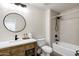 Neutral bathroom featuring tile surround, modern sink, and vanity with black fixtures at 10102 E Dreyfus Ave, Scottsdale, AZ 85260