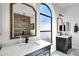 Modern bathroom featuring dual vanities with black hardware, gold-trimmed mirrors, and decorative lighting at 10102 E Dreyfus Ave, Scottsdale, AZ 85260