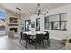 Bright dining room features modern lighting fixture, marble table and view to fireplace at 10102 E Dreyfus Ave, Scottsdale, AZ 85260
