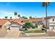 Charming single-story home with a red tile roof, manicured lawn, mature trees, and a two-car garage in a sunny neighborhood at 10102 E Dreyfus Ave, Scottsdale, AZ 85260