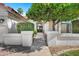 Welcoming front entrance with a beautiful mature tree and a decorative doorway at 10102 E Dreyfus Ave, Scottsdale, AZ 85260