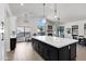 Spacious open-concept kitchen with large island, pendant lighting, and stone fireplace feature at 10102 E Dreyfus Ave, Scottsdale, AZ 85260