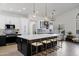 Spacious kitchen with seating at the island, custom cabinets, and modern appliances at 10102 E Dreyfus Ave, Scottsdale, AZ 85260