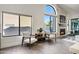 Inviting living room with stone fireplace, large windows and natural light at 10102 E Dreyfus Ave, Scottsdale, AZ 85260