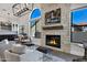 Bright living space featuring a beautiful stone fireplace and comfortable seating at 10102 E Dreyfus Ave, Scottsdale, AZ 85260