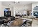 Open-concept living area with a fireplace and a view of the kitchen and dining area at 10102 E Dreyfus Ave, Scottsdale, AZ 85260