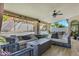 Comfortable covered patio with plush seating, a fire pit, and a view of the pool and yard at 10102 E Dreyfus Ave, Scottsdale, AZ 85260